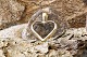 This beautiful 
pendant, shaped 
like a gold 
heart in 14 
carat gold, is 
designed simply 
but ...