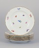 Meissen, Germany. A set of six dinner plates in porcelain, hand-painted with 
different polychrome flower motifs and a gold rim.
