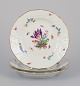 Meissen, Germany. Three plates in porcelain, hand-painted with different 
polychrome flowers and butterflies, and a gold rim.