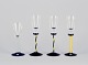 Margareta Hennix for Reijmyre, Sweden. A set of four schnapps glasses. Handmade 
and mouth-blown art glass in blue, yellow, and clear glass.