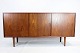 Teak sideboard of Danish design with sliding doors with internal shelves and drawers from around ...