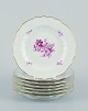 Meissen, 
Germany. A set 
of seven 
porcelain 
plates 
hand-painted 
with purple 
flower 
decoration and 
...