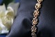 Beautiful and detailed gold bracelet with links shaped like a knot. The bracelet is made of 14 ...