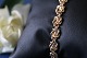 Beautiful and 
detailed gold 
bracelet with 
links shaped 
like a knot. 
The bracelet is 
made of 14 ...