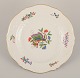 Meissen, Germany. Hand-painted dinner plate featuring a butterfly on a branch 
and polychrome flower motifs. Gold rim.
