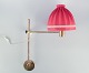Hans Agne 
Jakobsson, 
Swedish 
designer. Wall 
lamp in brass 
with a 
lampshade in 
red fabric. ...