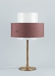 Luxus, Sweden. Large table lamp in brass with a shade in plastic and brown fabric.In beautiful ...