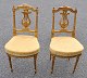 A pair of French gilt salon chairs, 19th/20th century. Louis XVI style. With lyre-shaped cuts in ...