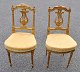 A pair of 
French gilt 
salon chairs, 
19th/20th 
century. Louis 
XVI style. With 
lyre-shaped 
cuts in ...