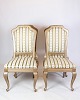 Set of four 
antique rococo 
chairs in 
gilded wood 
with striped 
fabric from 
around the ...