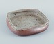 Nils Kähler for Kähler, ceramic bowl on four low feet.Square shape. Glaze in earthy ...