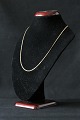 Thin gold chain in 14 carat gold, forged in a minimalist design that makes it ideal for the vast ...
