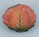 Ipsens Enke, Denmark. Ceramic bowl with wavy rim.Design depicting plant growth. Glaze in ...