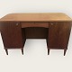 Freestanding desk in teak veneer. 2 cupboards and a drawer at one side, rounded corners and ...