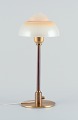 Fog & Mørup. 
Table lamp with 
a stem in 
patinated 
brass, fitted 
with a 
"Spejlæg" 
(Fried Egg) ...