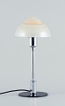 Fog & Mørup. Table lamp with a chrome stem, fitted with a "Spejlæg"(Fried Egg) glass shade.In ...