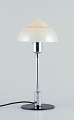 Fog & Mørup. 
Table lamp with 
a chrome stem, 
fitted with a 
"Spejlæg"(Fried 
Egg) glass 
shade.
In ...