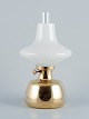 Henning Koppel 
for Louis 
Poulsen. 
Petronella oil 
lamp in brass 
with an opal 
glass ...