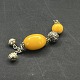 Length 19 cm.
Long pendant 
in silvery 
metal and two 
beads in orange 
bakelite and 
two bells at 
...