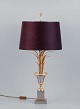In the style of Maison Jansen. Large table lamp in brass with a base in the shape of palm leaves ...
