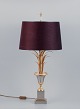 In the style of 
Maison Jansen. 
Large table 
lamp in brass 
with a base in 
the shape of 
palm leaves ...