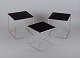 Poul Kjærholm, Danish furniture designer. A set of nesting tables PK 71.
Brushed steel frame, black acrylic tops.