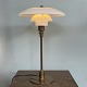 Poul Henningsen. Table lamp model TrePH, jubilee model with stem and base of bronzed brass, ...
