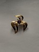 Fine gold 
brooch with 
nice curved 
pattern, in 14 
carat gold and 
blue stone in 
the middle. The 
...