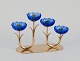 Gunnar Ander 
for Ystad 
Metall, Sweden. 
Candlestick 
holder in brass 
and blue art 
glass shaped 
...