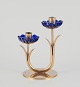 Gunnar Ander 
for Ystad 
Metall, Sweden. 
Candlestick 
holder in brass 
and blue art 
glass shaped 
...