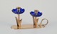 Gunnar Ander 
for Ystad 
Metall, Sweden. 
Candlestick 
holder in brass 
and blue art 
glass shaped 
...