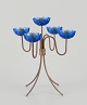 Gunnar Ander for Ystad Metall, Sweden. Tall candlestick holder in brass and blue 
art glass shaped like flowers. For five candles.