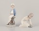 Lladro, Spain. Two porcelain figurines. Boy in sailor outfit with a model ship in hand and a ...