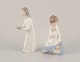 Lladro, Spain. 
Two porcelain 
figurines. Girl 
with a 
nightstand lamp 
and an angel 
figurine with a 
...