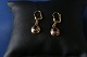 These gold earrings in 14 carat gold, with inlaid amethyst are high class, and are elegant for ...