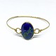 Bangle of 14 
kt. gold set 
with a cabochon 
cut azurite.
The bangle can 
be opened.
Inner ...