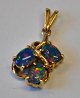 14k gold 
pendant with 3 
cut opals. 20th 
century. 
Stamped. H: 2.5 
cm.