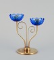 Gunnar Ander 
for Ystad 
Metall, Sweden. 
Brass 
candlestick 
holder with 
blue glass 
sleeves. For 
two ...
