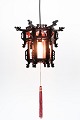 Made of wood with intricate carvings, this pendant lamp reflects the rich artistic heritage of ...