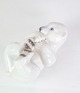 The Bing & 
Grøndahl 
porcelain 
figurine of a 
polar bear cub 
lying on its 
back with 
number 2538 is 
...