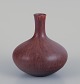 Carl Harry Stålhane (1920-1990) for Rörstrand, Sweden. Ceramic vase with a round 
body and slim neck. Glazed in brown tones.