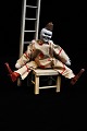 Old French circus toy clown in painted wood with clown clothes in fabric, as 
well as a wooden chair and ladder...