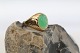 This beautiful 
lady's ring is 
forged in solid 
14 carat gold, 
and topped with 
a beautiful 
green ...