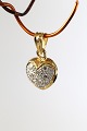 Heart-shaped pendant in 14 carat gold, with diamonds. Stamped 585. Very 
exclusive.