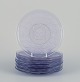 Lalique-style. A set of ten glass plates designed with flower motifs in purple 
glass.