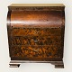 Lacquered 
secretary in 
dark veneer 
with writing 
board and 
curved lid. Has 
age-related 
signs of ...