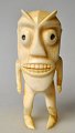 Greenlandic 
tupilak, 20th 
century. 
Standing person 
with mask. 
Carved bone. 
H.: 11.5 cm. 
...