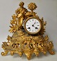 French mantel clock in gilded zinc, 19th century. New rococo. Decoration with boy with basket of ...