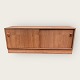 Low sideboard / cabinet in teak veneer with sliding doors and removable plinth. Very nice used ...