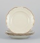 KPM, Poland. A set of four large deep porcelain plates in cream color.
Gold-rim decoration.